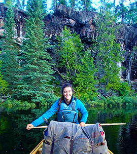 A picture of Alexia smiling in a canoe.